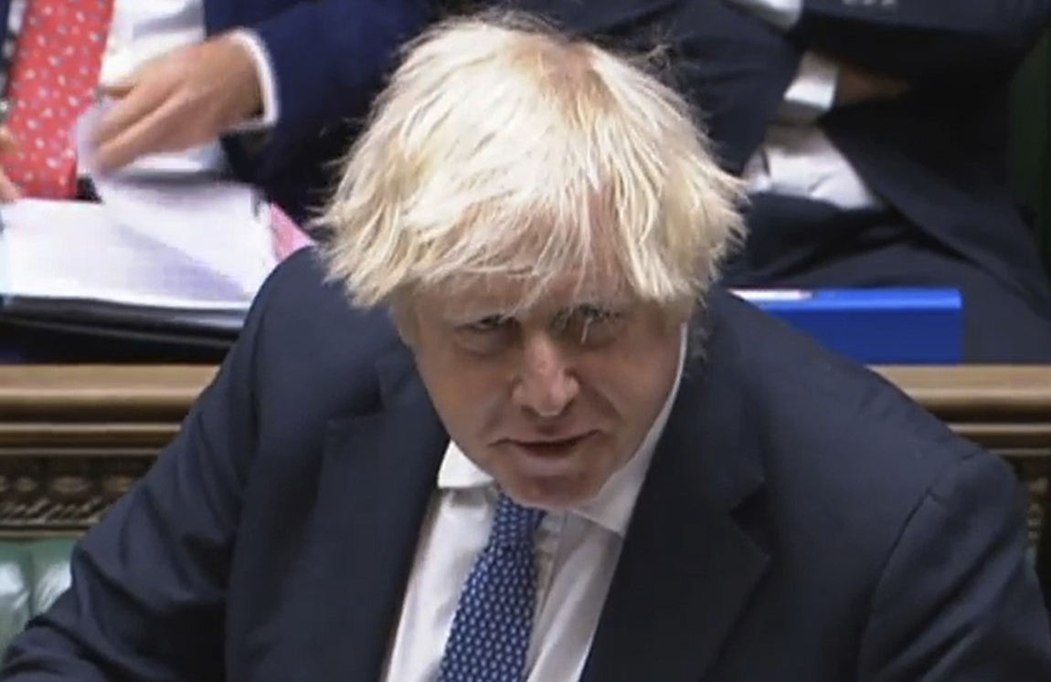 In this grab taken from video, Britain's Prime Minister Boris Johnson speaks during Prime Minister's Questions in the House of Commons, London, Wednesday, Dec. 8, 2021. Johnson says no U.K. government minister will attend the Beijing Olympics. Johnson on Wednesday called it â€œeffectivelyâ€  a diplomatic boycott. Johnson was asked in the House of Commons whether the U.K. will join the United States, Australia and Lithuania in a diplomatic boycott of the Winter Games. (House of Commons/PA via AP)