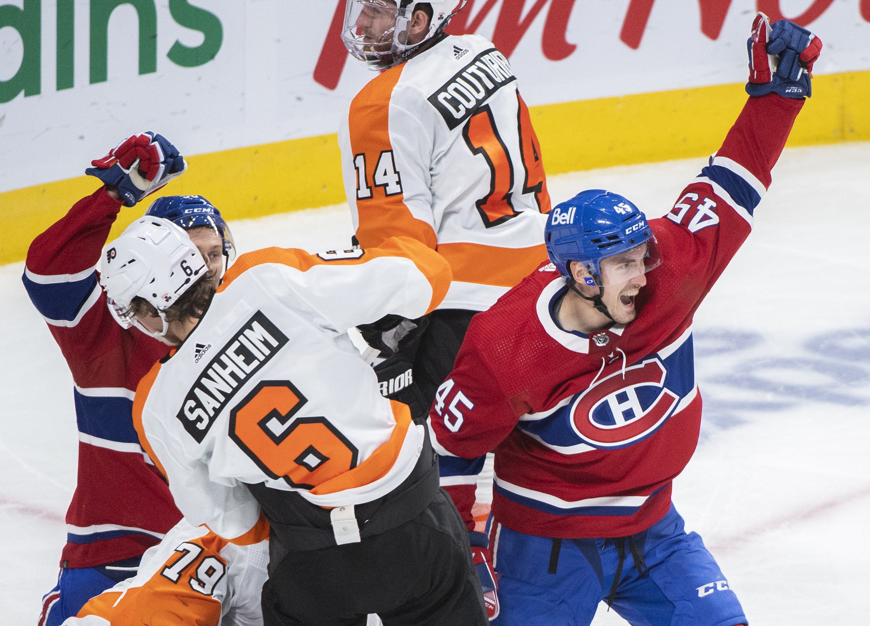 Montreal Canadiens' Laurent Dauphin (45) scores against Philadelphia Flyers goaltender Carter Hart (79) as Flyers' Travis Sanheim (6) defends during third period NHL hockey action in Montreal, Thursday, December 16, 2021. THE CANADIAN PRESS/Graham Hughes