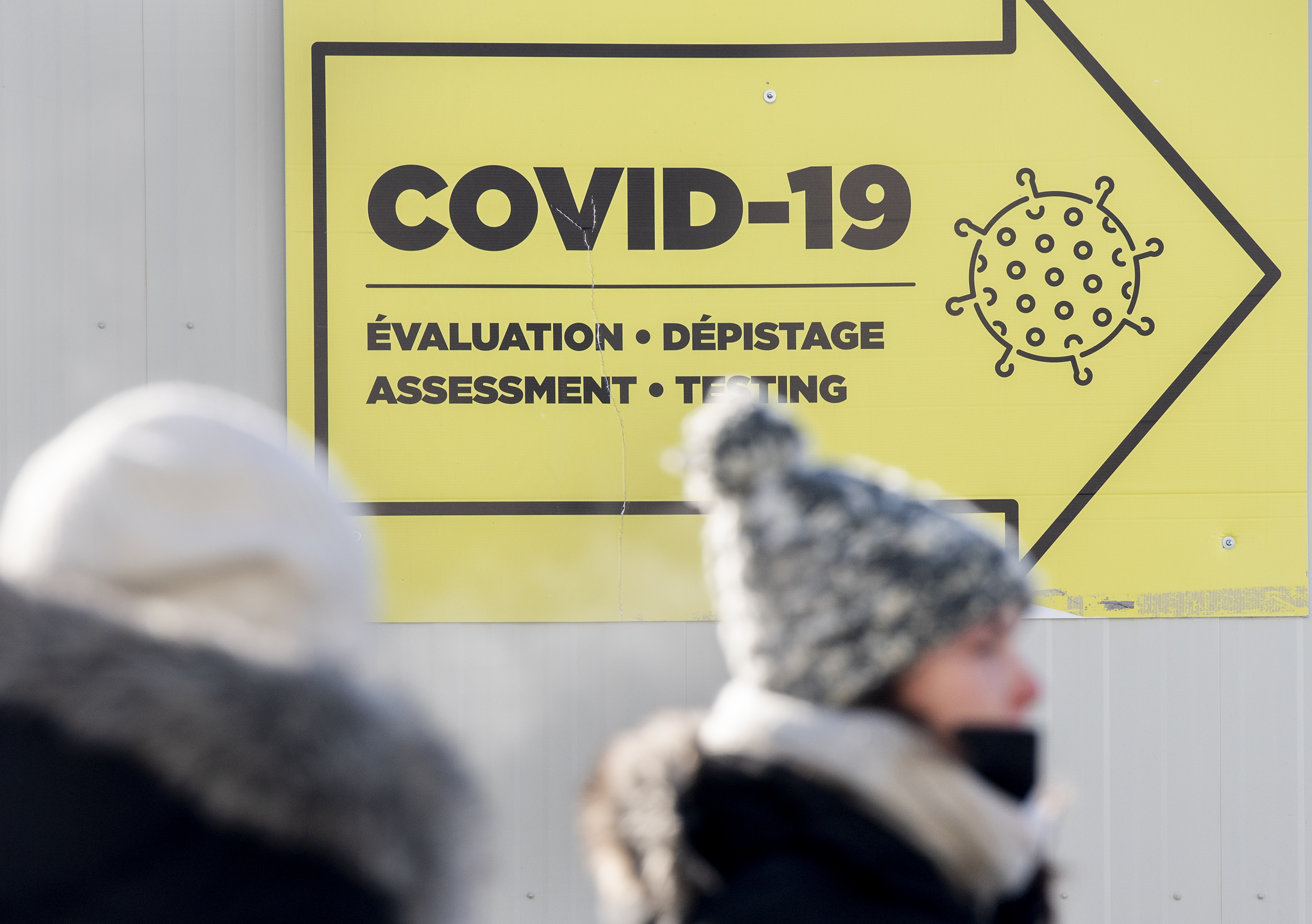 People are shown outside a COVID-19 testing site in Montreal, Saturday, January 15, 2022, as the  pandemic continues in Canada. THE CANADIAN PRESS/Graham Hughes