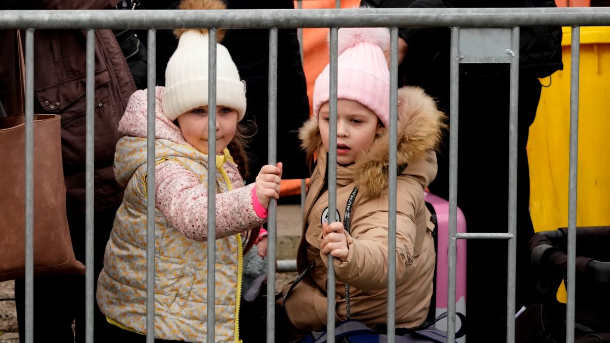 Deux jeunes filles font la queue à la frontière ukrainienne-polonaise, le 29 mars 2022.