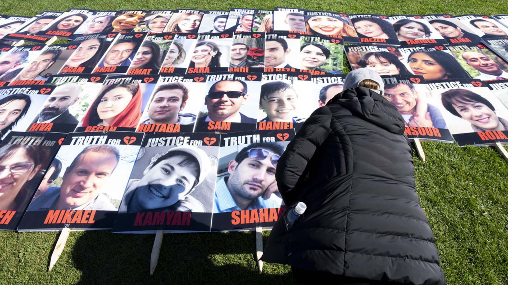 Une femme place une pancarte avec la photo d'une personne tuée sur le vol 752 lors d'une manifestation sur la colline du Parlement, le mardi 4 octobre 2022 à Ottawa. Les proches des personnes tuées lorsque l'armée iranienne a abattu l'avion en janvier 2020 affirment que le Canada est devenu un refuge sûr pour les responsables du régime.