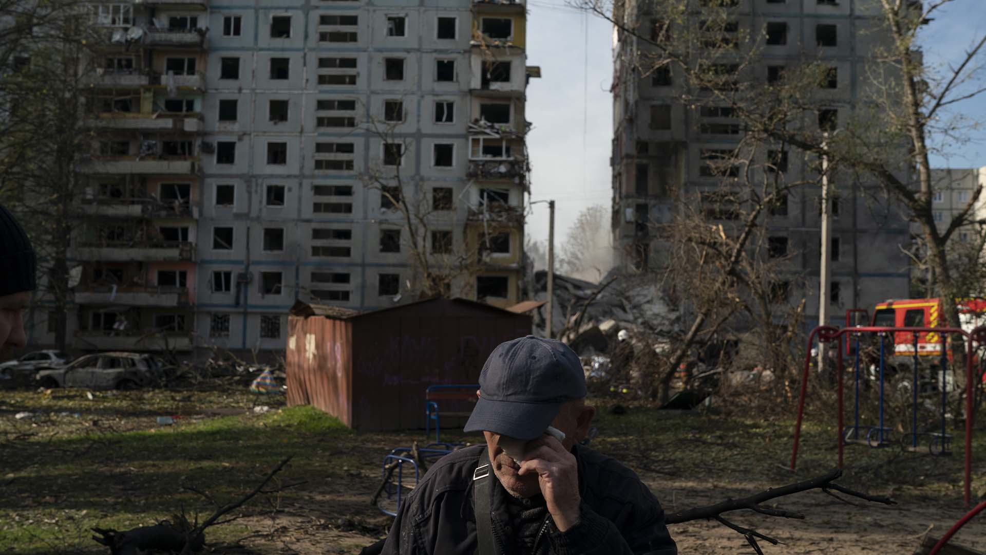Mucola Markovich, 76 ans, essuie une larme à côté d'un bâtiment résidentiel fortement endommagé après une attaque russe dans un quartier résidentiel de Zaporijjia, le 9 octobre 2022.