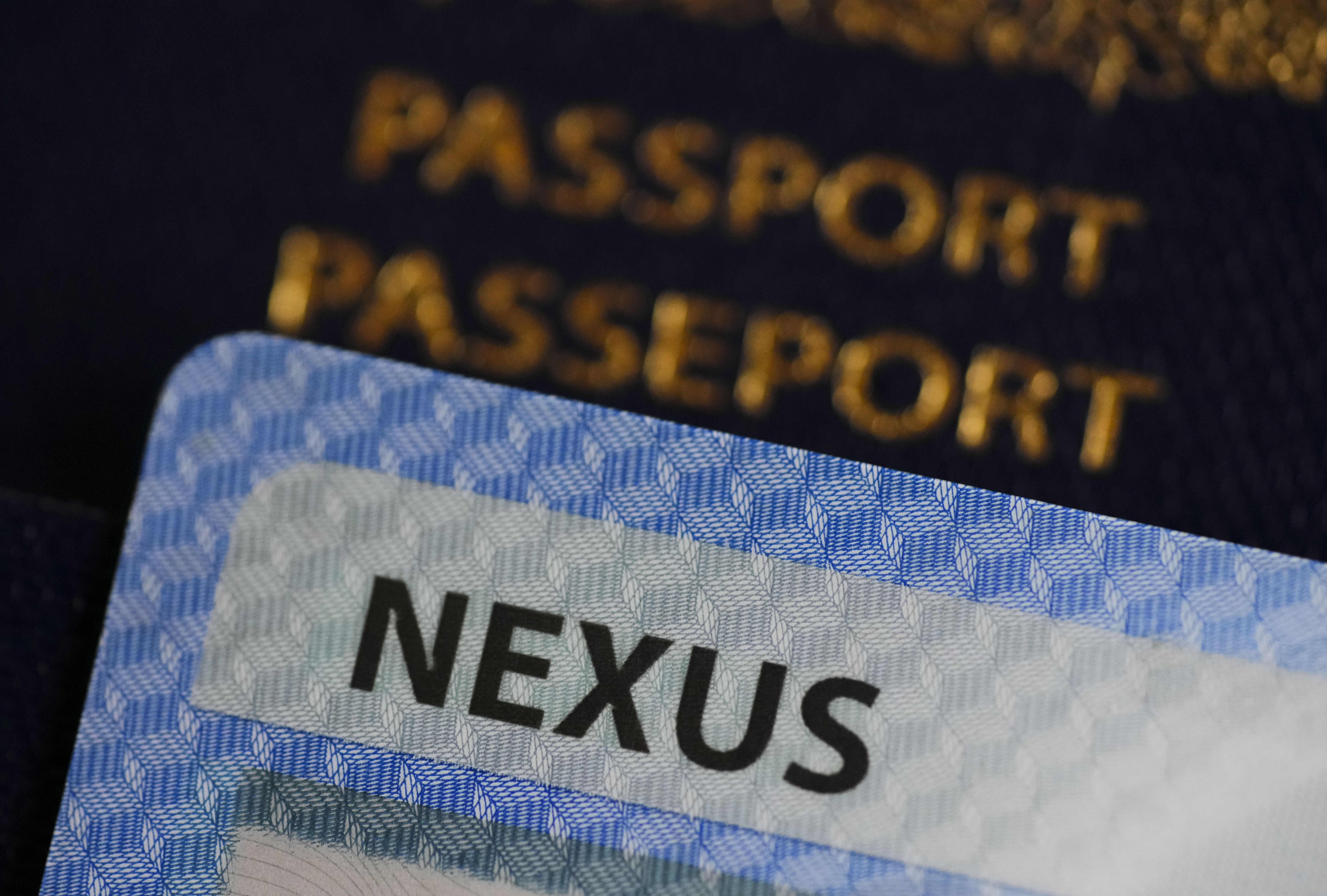 A NEXUS card and a Canadian passport are pictured in Ottawa on Tuesday, Jan. 17, 2023. THE CANADIAN PRESS/Sean Kilpatrick