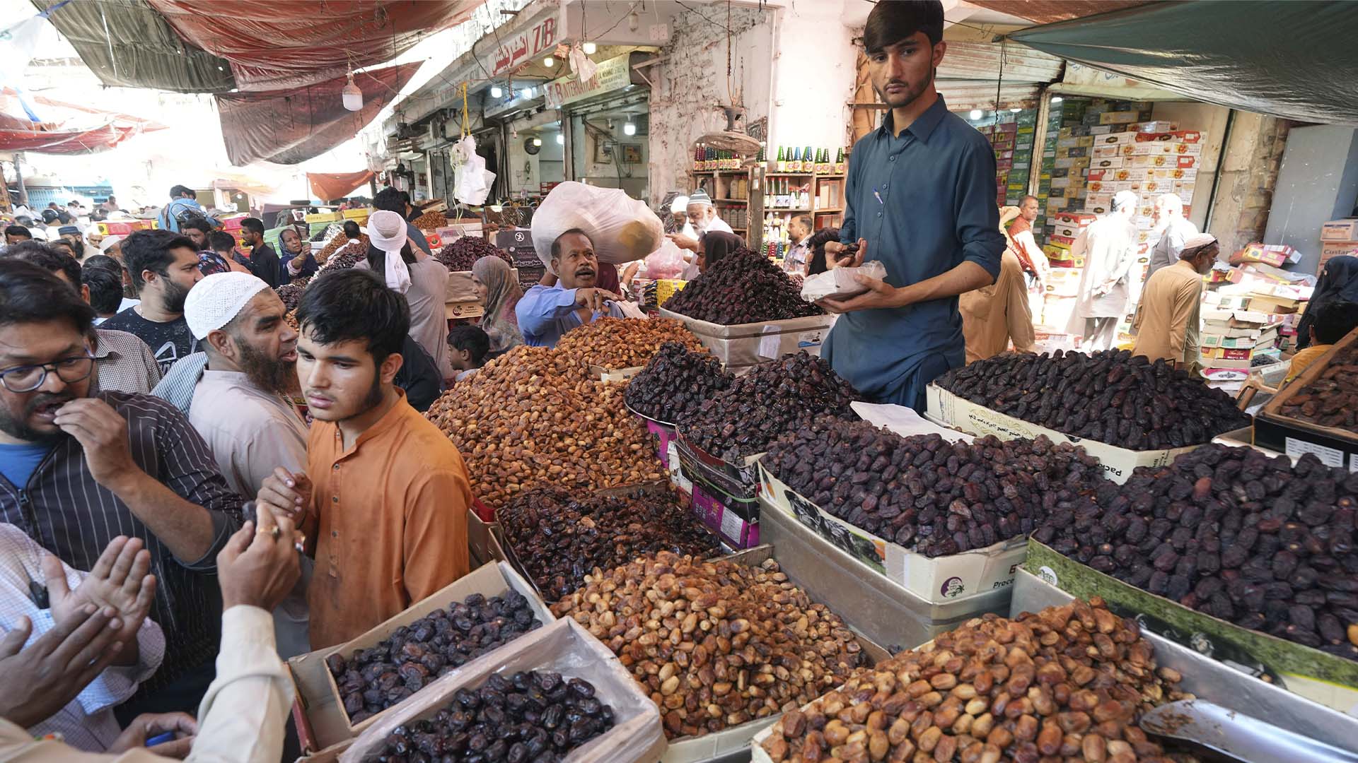 Les gens visitent un marché pour acheter des dattes et d'autres articles avant le prochain mois de jeûne musulman du Ramadan, à Karachi, au Pakistan, le mardi 21 mars 2023.