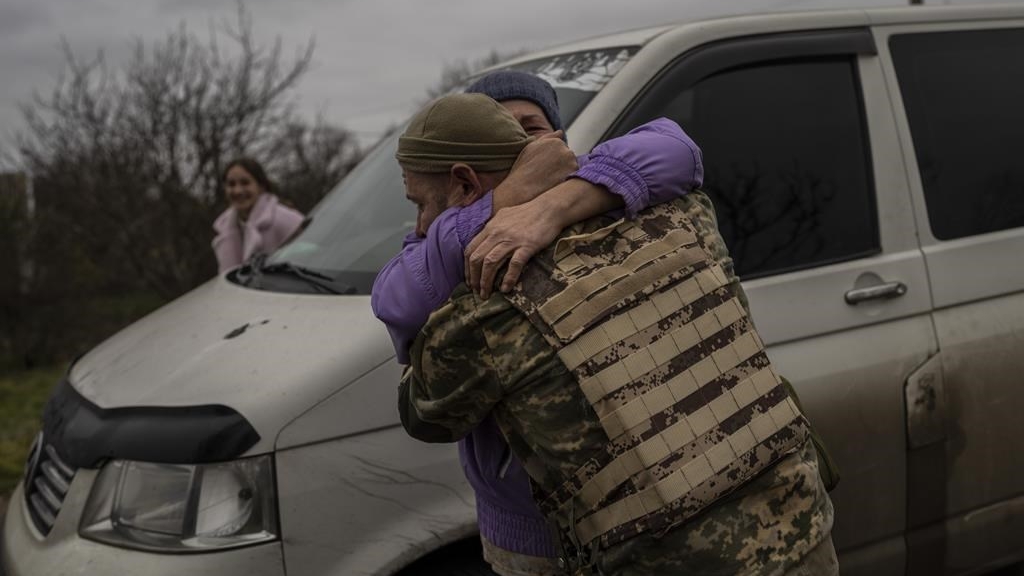 In the village of Vavylove, a Ukrainian serviceman embraces his mother for the first time since Russian troops withdrew from the Kherson region, southern Ukraine, Sunday, Nov. 13, 2022. 