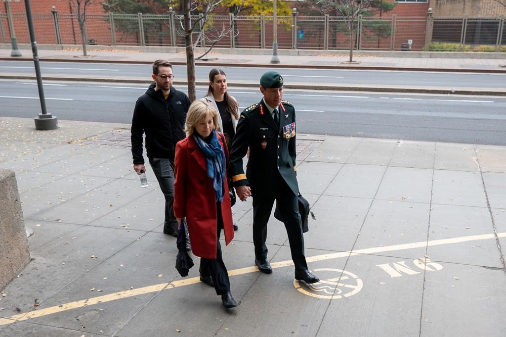 Maj.-Gen. Dany Fortin, right, arrives with his wife Madeleine Collin at a Gatineau, Que. courthouse on Tuesday, Oct. 25, 2022. THE CANADIAN PRESS/Spencer Colby