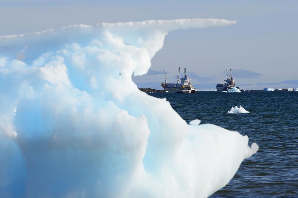 Ships are framed by pieces of melting sea ice in Frobisher Bay in Iqaluit, Nunavut on Wednesday, July 31, 2019. Scientists are telling the global climate conference in Egypt that the loss of summer Arctic sea ice is now inevitable. THE CANADIAN PRESS/Sean Kilpatrick