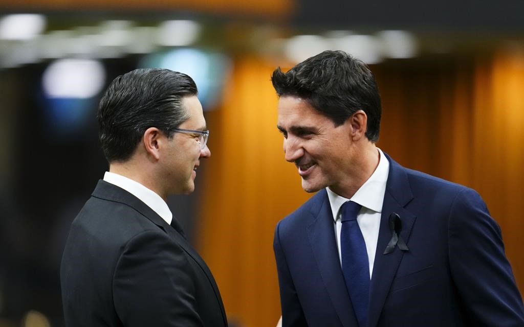 Prime Minister Justin Trudeau and Conservative leader Pierre Poilievre greet each other as they gather in the House of Commons on Parliament Hill, in Ottawa on Thursday, Sept. 15, 2022. A new poll says the Tories are retaining a small lead over the governing Liberals and have slightly widened the gap. THE CANADIAN PRESS/Sean Kilpatrick