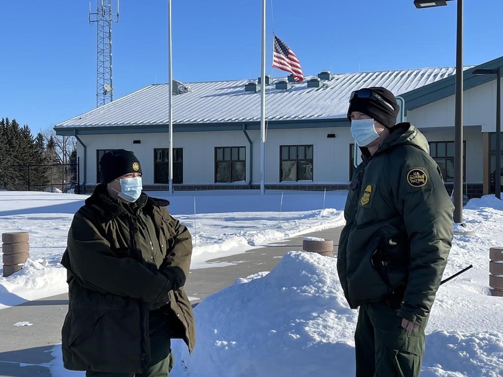 U.S. Border Patrol agents Katy Siemer, left and David Marcus stand outside the Customs and Border Protection facility in Pembina, N.D., on Tuesday, Jan. 25, 2022. A year after a family of four from India froze to death while trying to walk to the United States from Manitoba, the agency tasked with patrolling the border says others have not been deterred from attempting the same treacherous journey. THE CANADIAN PRESS/James McCarten