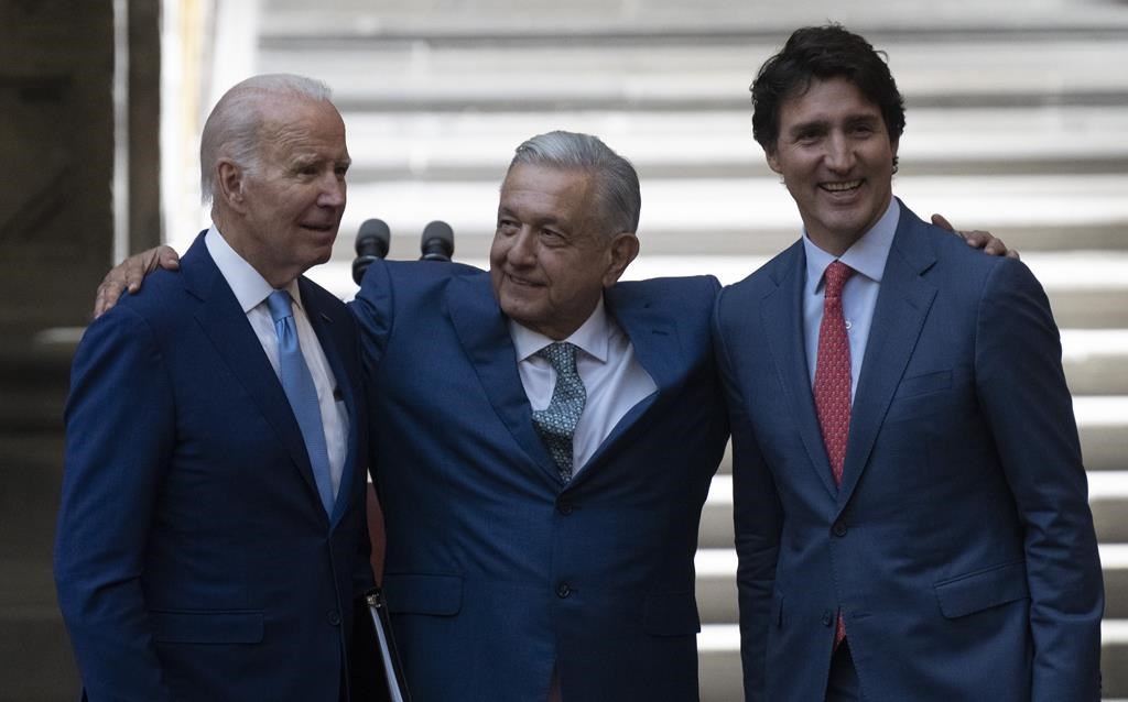 Mexican President Andres Manuel Lopez Obrador embraces United States President Joe Biden and Prime Minister Justin Trudeau following a joint news conference at the North American Leaders Summit, Tuesday, January 10, 2023 in Mexico City, Mexico. THE CANADIAN PRESS/Adrian Wyld