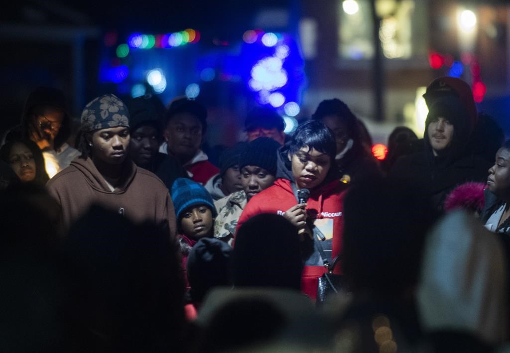 Family members of Nicous D'Andre Spring attend a vigil in his memory in Montreal, Friday, Dec. 30, 2022. The family of a Montreal man who died after an altercation with guards at a detention centre while unlawfully detained is demanding an inquiry into his death. THE CANADIAN PRESS/Graham Hughes