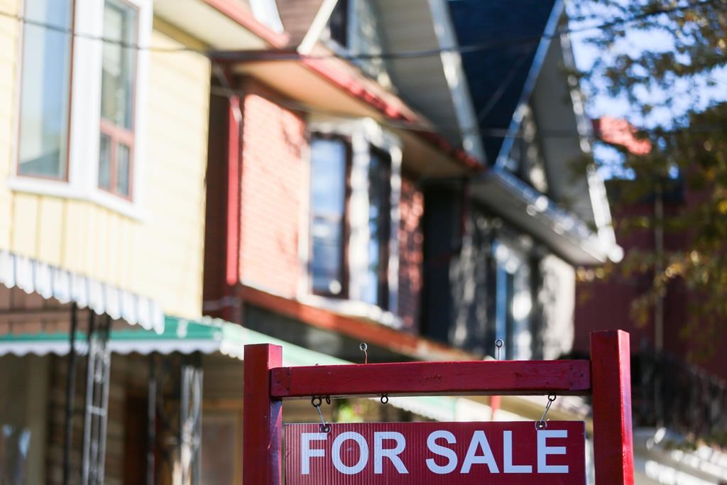 The Canadian Real Estate Association says the number of homes that changed hands last month was up 0.9 per cent compared with October 2022 as the national average home price rose to $656,625 -- up 1.8 per cent from a year ago. A real estate sign is displayed in front of a house in Toronto on Wednesday, September 29, 2021. THE CANADIAN PRESS/Evan Buhler