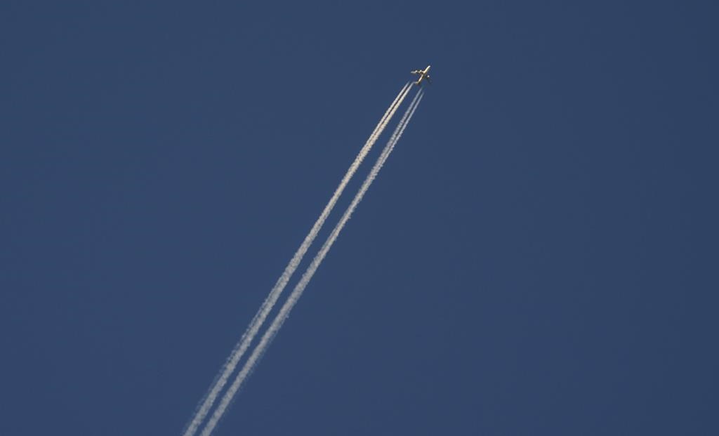 An airliner cuts through the skies over Montreal, Wednesday, Dec. 23, 2020. An aviation expert says the seizure of four Flair Airlines planes over the weekend points to the fierce competition and high demand playing out in the Canadian air travel industry. THE CANADIAN PRESS/Paul Chiasson