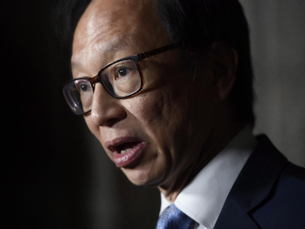 Sen. Yuen Pau Woo, facilitator of the Independent Senators Group, speaks to reporters during a press conference in the Senate foyer on Parliament Hill in Ottawa on Tuesday, May 29, 2018. He says a prospective foreign influence registry must not be "overly broad" to avoid unfairly targeting members of the Chinese-Canadian community and other minority groups. THE CANADIAN PRESS/Justin Tang