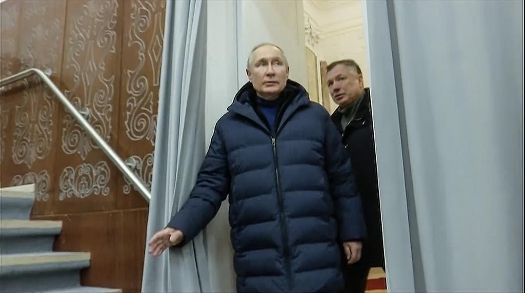 In this photo taken from video released by Russian TV Pool on Sunday, March 19, 2023, Russian President Vladimir Putin escorting by Russian Deputy Prime Minister Marat Khusnullin visits the Mariupol theater during his visit to Mariupol in Russian-controlled Donetsk region, Ukraine. Putin has traveled to Crimea to mark the ninth anniversary of the Black Sea peninsula's annexation from Ukraine (Pool Photo via AP)