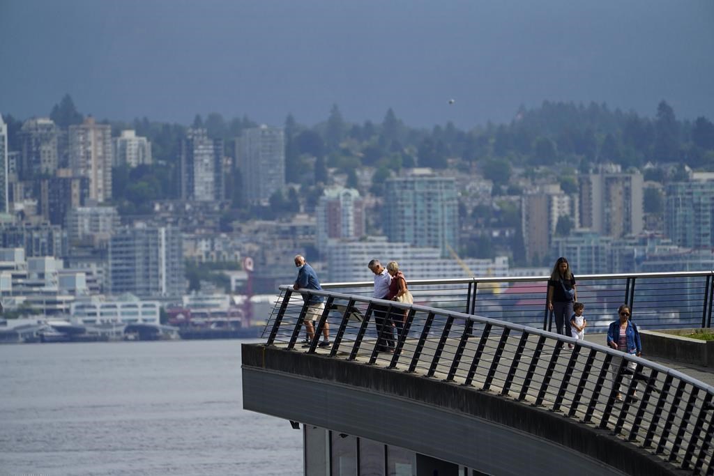People make their way along the waterfront in downtown Vancouver, B.C., on Wednesday, Aug 18, 2021. THE CANADIAN PRESS/Sean Kilpatrick