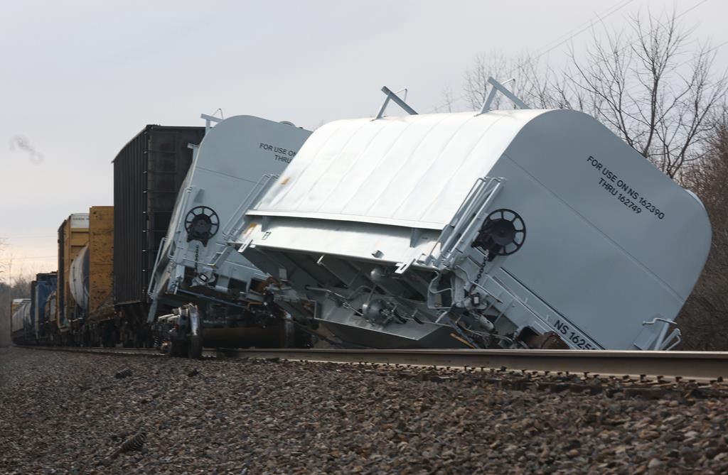 A Norfolk Southern cargo train car leans off the tracks after derailing in Clark County, Ohio, at a train crossing with Ohio 41 Saturday, March 4, 2023. (Bill Lackey/Springfield-News Sun via AP)