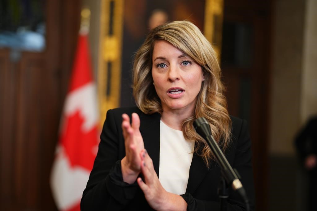 Foreign Affairs Minister Melanie Joly speaks to reporters in the foyer of the House of Commons on Parliament Hill in Ottawa on Monday, March 27, 2023. The federal government says it has deployed members of its Global Affairs Standing Rapid Deployment Team to Djibouti due to the volatile and rapidly deteriorating situation in Sudan. THE CANADIAN PRESS/Sean Kilpatrick