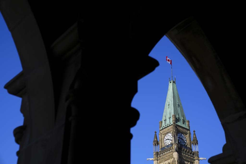 The Canada flag flies on top of the Peace Tower on Parliament Hill in Ottawa on Monday, March 6, 2023. Nine First Nations police service say Ottawa's "deliberate and wilful underfunding" of policing in their communities amounts to discrimination. THE CANADIAN PRESS/Sean Kilpatrick