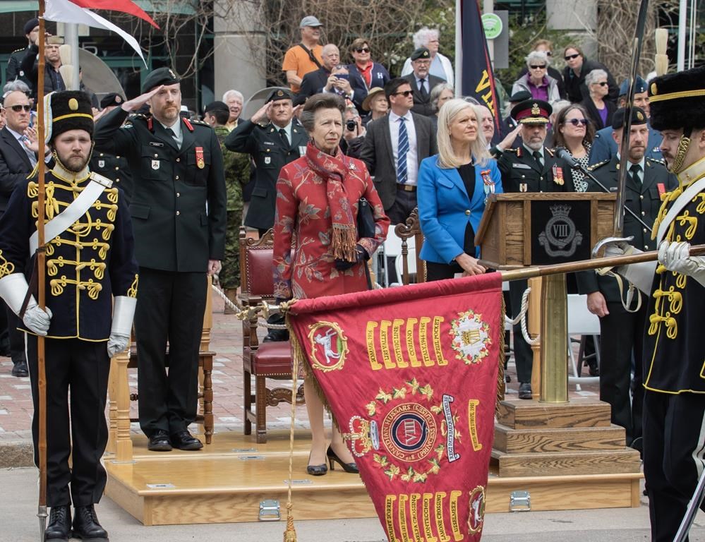 Princess Anne (centre), Colonel Gregory Kennedy Command, 37 Canadian Brigade Group (left) and Moncton mayor Dawn Arnold (right) watch the march past during the 8th Canadian Hussars Exercise of the Freedom of the City of Moncton Parade on Saturday May 20, 2023.THE CANADIAN PRESS/Ron Ward 