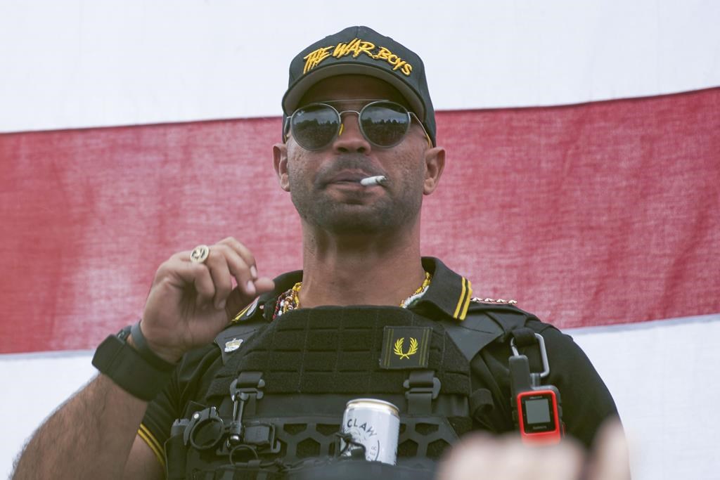 FILE - Proud Boys leader Henry "Enrique" Tarrio wears a hat that says The War Boys during a rally in Portland, Ore., on Sept. 26, 2020. The Justice Department said Thursday, Aug. 17, 2023, it is seeking 33 years in prison for Tarrio, convicted of seditious conspiracy in one of the most serious cases to emerge from the Jan. 6, 2021, attack on the U.S. Capitol. (AP Photo/Allison Dinner, File)