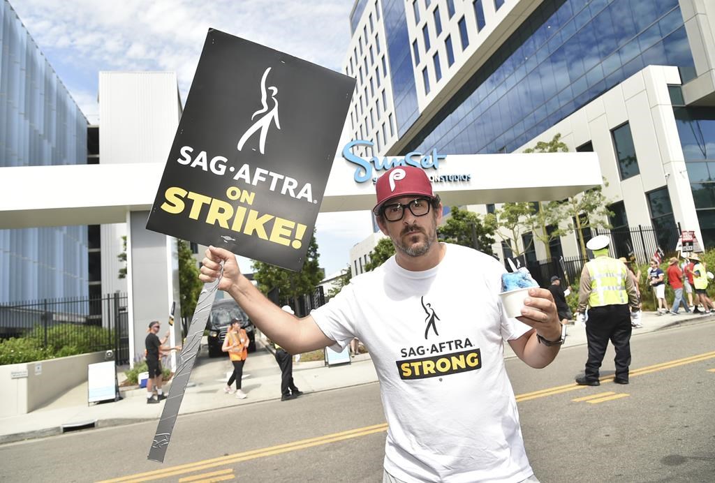 Adam Shapiro poses on a picket line outside Netflix studios on Tuesday, Aug. 1, 2023, in Los Angeles. The actors strike comes more than two months after screenwriters began striking in their bid to get better pay and working conditions. (Photo by Richard Shotwell/Invision/AP)