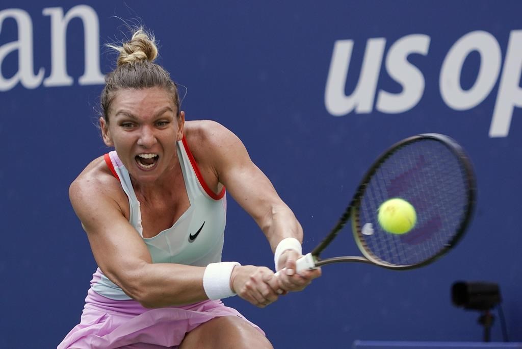 FILE - Simona Halep, of Romania, returns a shot to Daria Snigur, of Ukraine, during the first round of the U.S. Open tennis championships Aug. 29, 2022, in New York. Halep was dropped from the U.S. Open field on Monday, Aug. 21, 2023, because of a provisional doping suspension. (AP Photo/Seth Wenig, File)