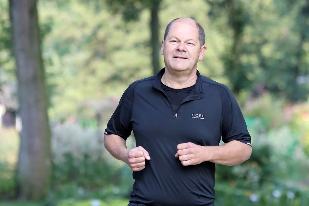 FILE - Hamburg's then First Mayor Olaf Scholz jogs across the grounds of the International Garden Show in the morning, in Hamburg, Germany, Aug. 30, 2013. German Chancellor Olaf Scholz fell while jogging and sustained bruises to his face, prompting him to cancel some appointments this weekend, the government said Saturday, Sept. 2, 2023. (Bodo Marks/dpa via AP)