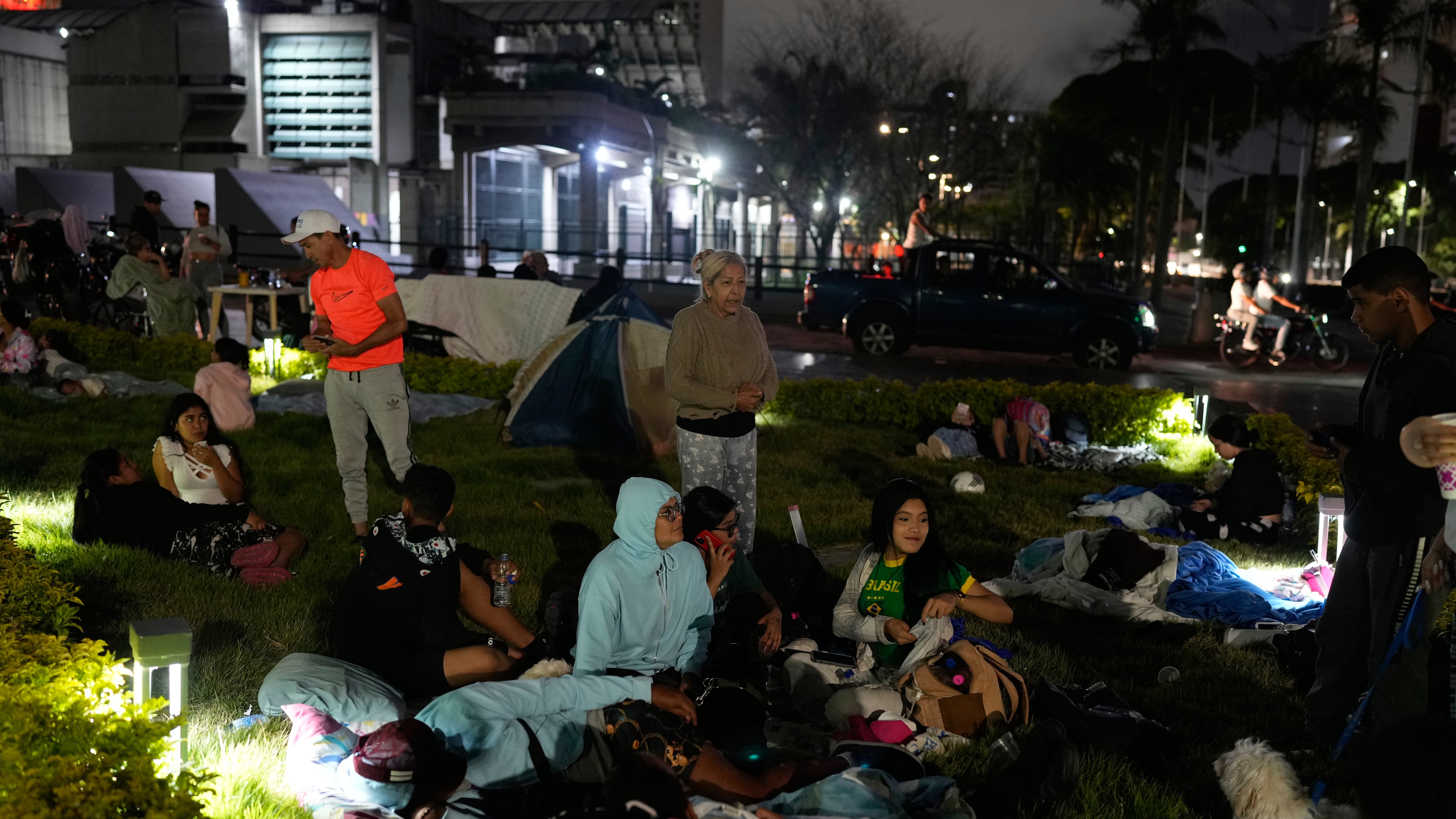 Des gens se préparent à passer la nuit à l'extérieur après le tremblement de terre qui a frappé Caracas, au Venezuela, le jeudi 25 juin 2026 (Photo AP/Ariana Cubillos)