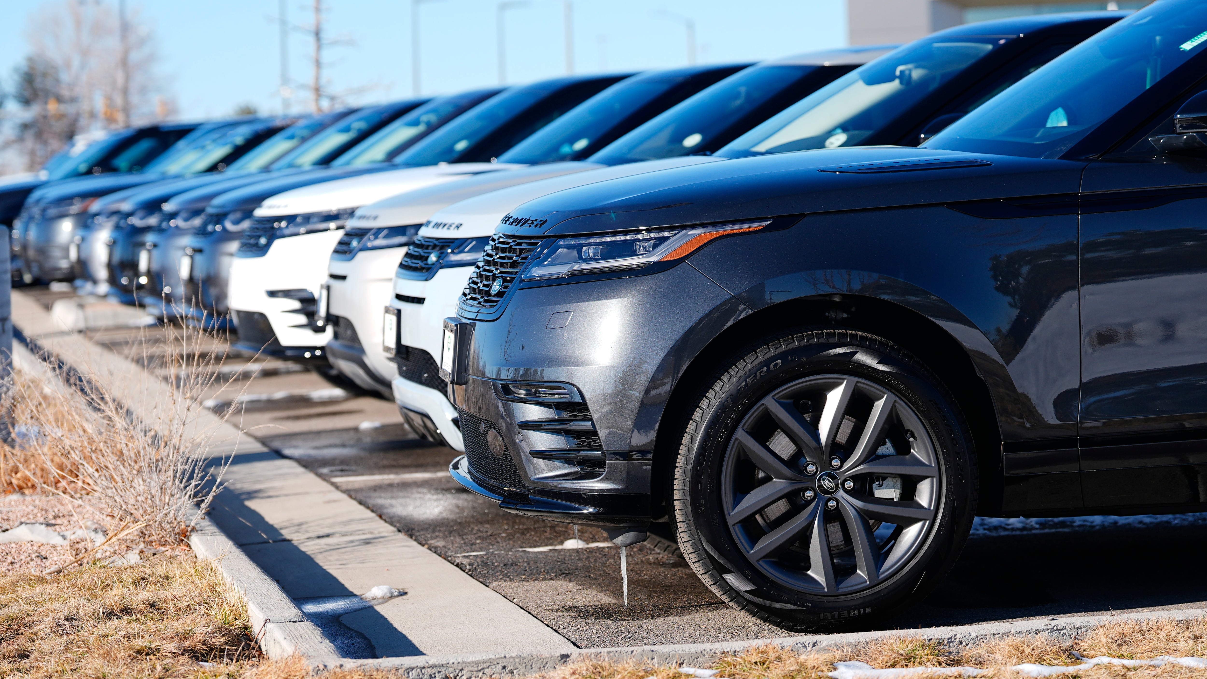 Unsold 2023 Velar, Discovery and Evoque sports utility vehicles sit outside a Land Rover dealership in Broomfield, Colo., on Feb. 11, 2024. (David Zalubowski / AP Photo)