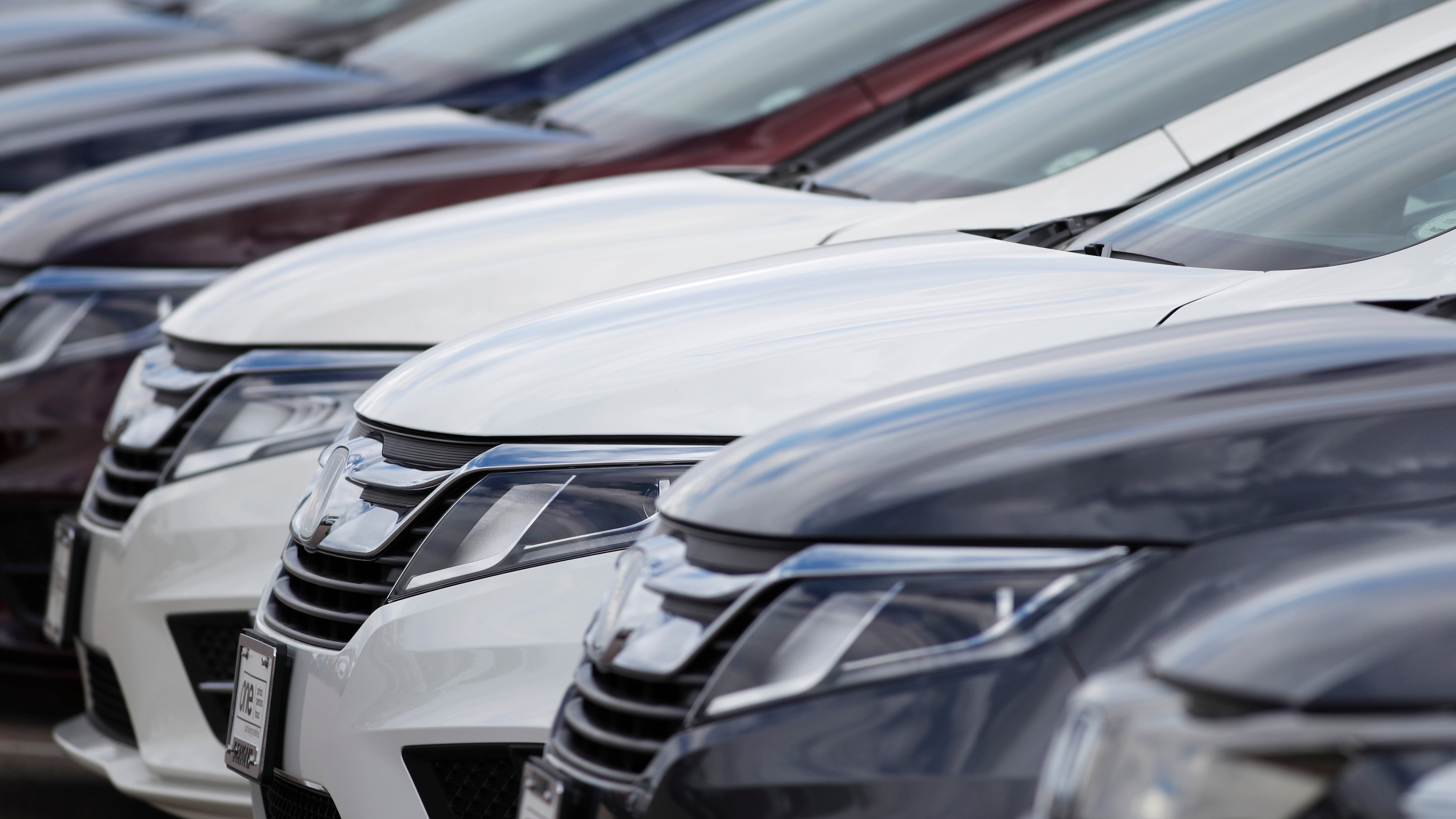 A long row of unsold 2020 Odyssey minivans sits at a Honda dealership in Highlands Ranch, Colo on April 5, 2020.
