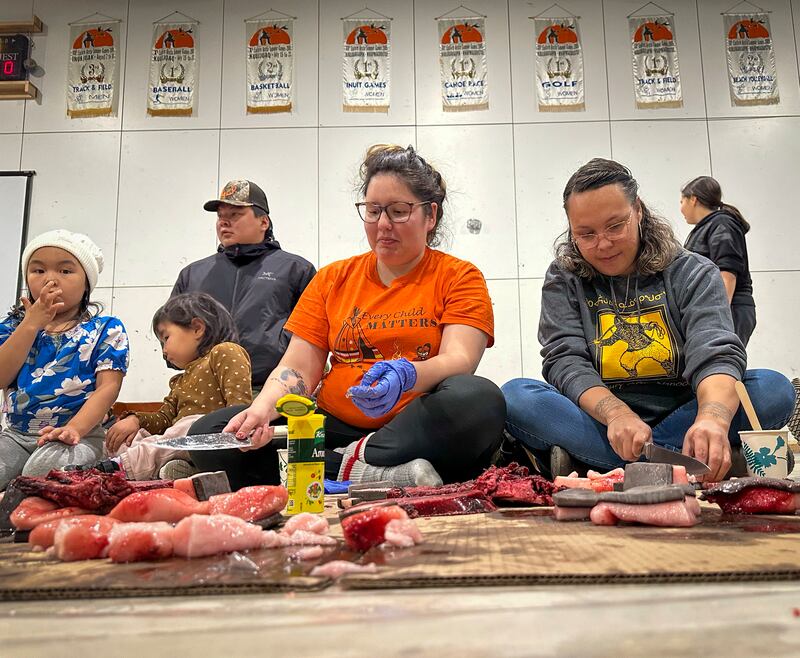Community members in Inukjuak gathered in October 2024 to share a feast of traditional food. (Photo by Lina Forero)