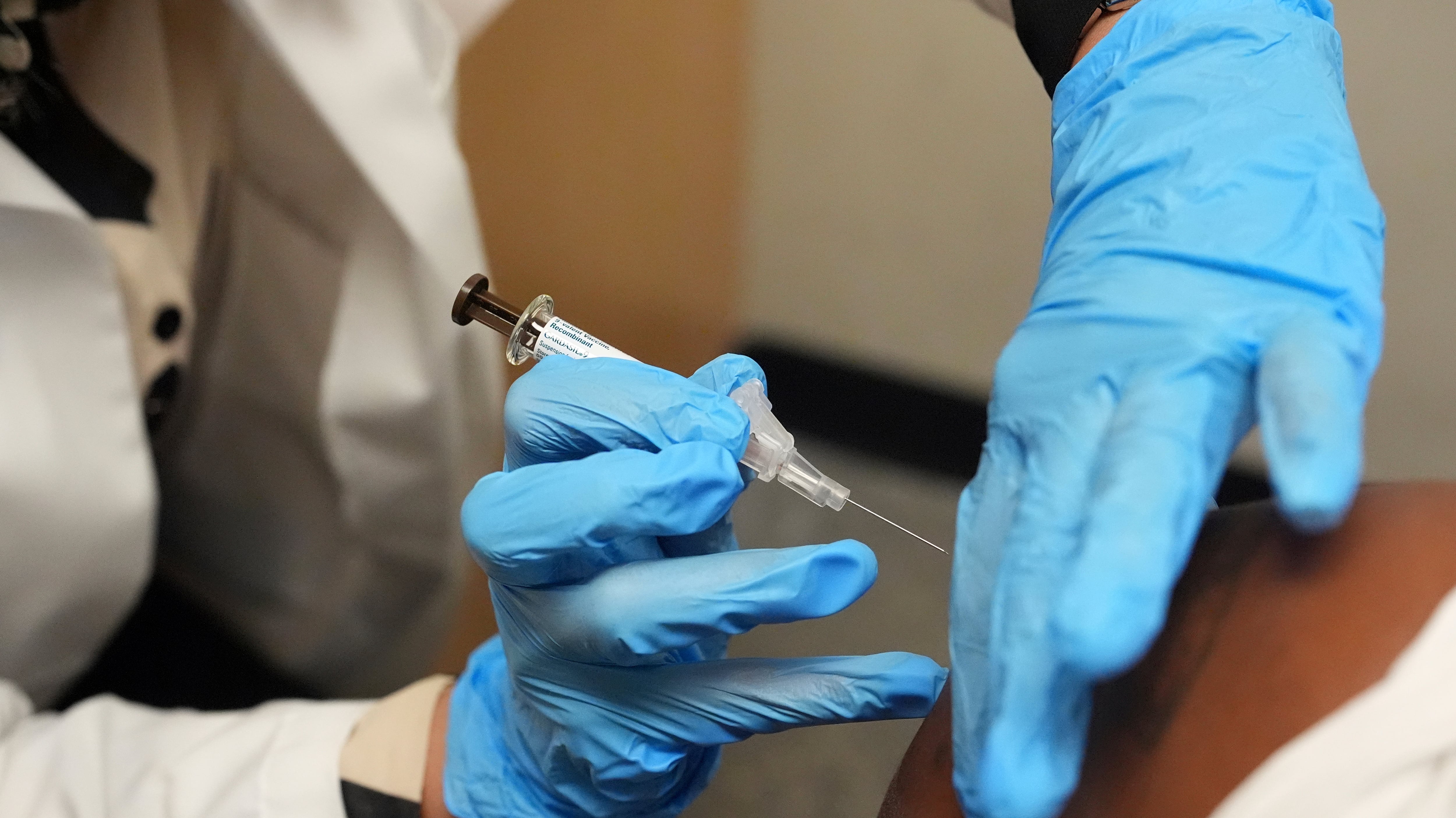 Pharmacy manager Aylen Amestoy administers a patient with a vaccine protecting against human papillomavirus (HPV) at a CVS Pharmacy in Miami on Sept. 9, 2025. (Rebecca Blackwell / AP Photo)